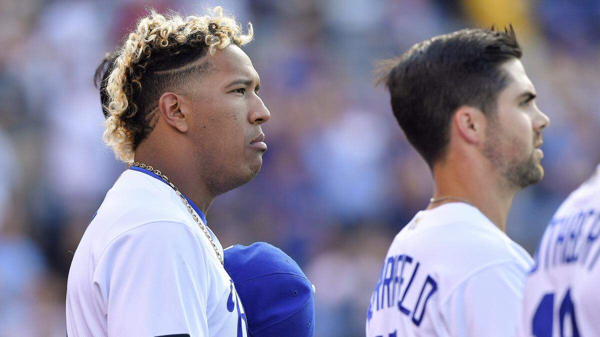 If you’re selected to sing the national anthem at a Royals game, consider playing it straight. Remember, everyone (including players like catcher Sal Perez, left, and infielder Whit Merrifield) will be watching.