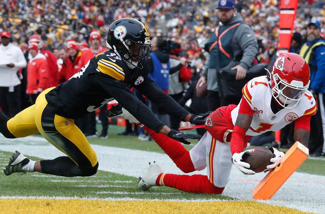 Kansas City Chiefs wide receiver Xavier Worthy (No. 1) dives past Pittsburgh Steelers safety Minkah Fitzpatrick for a touchdown at the pylon during an NFL Week 17 game at Acrisure Stadium in Pittsburgh, Pennsylvania on Wednesday, Dec 25, 2024.