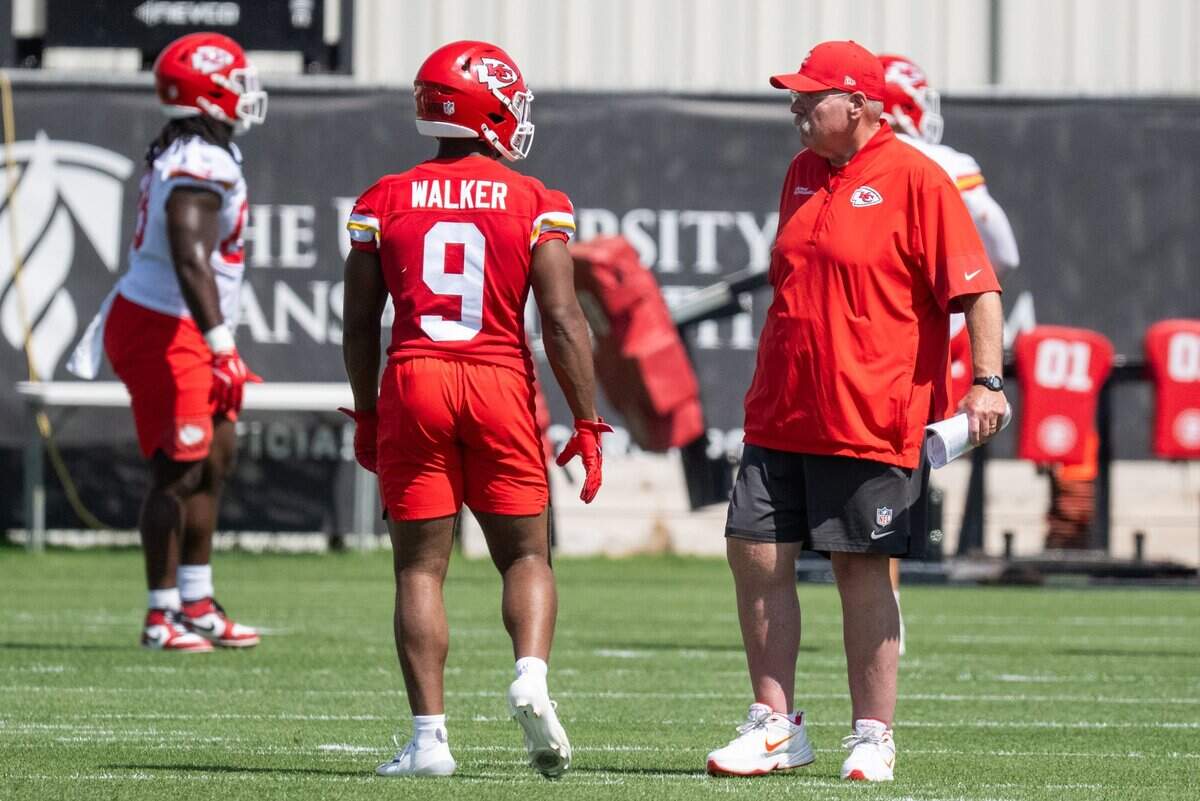 Kansas City Chiefs running back Kenneth Walker speaks with head coach Andy Reid between stretches at Chiefs Minicamp on Tuesday, June 9, 2026, in Kansas City.