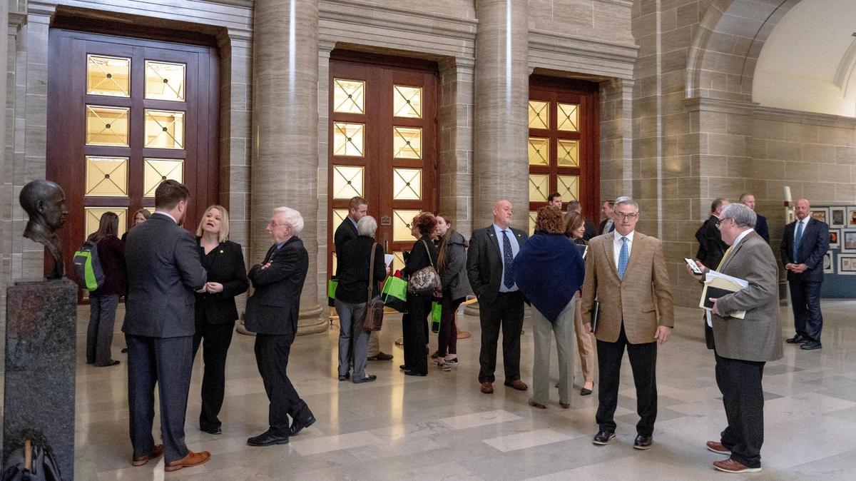 Lobbyists meet with state representatives outside of the Missouri House chamber on Tuesday, March 7, 2023, at the state Capitol in Jefferson City, Mo.