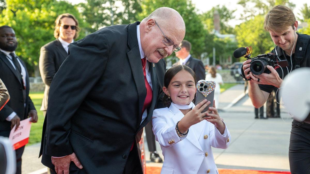 Chiefs coach Andy Reid took a selfie with Taylen Biggs, a social media personality, as he walked the red carpet before the Super Bowl LVIII championship ring presentation event on Thursday, June 13, 2024, at The Nelson-Atkins Museum in Kansas City.