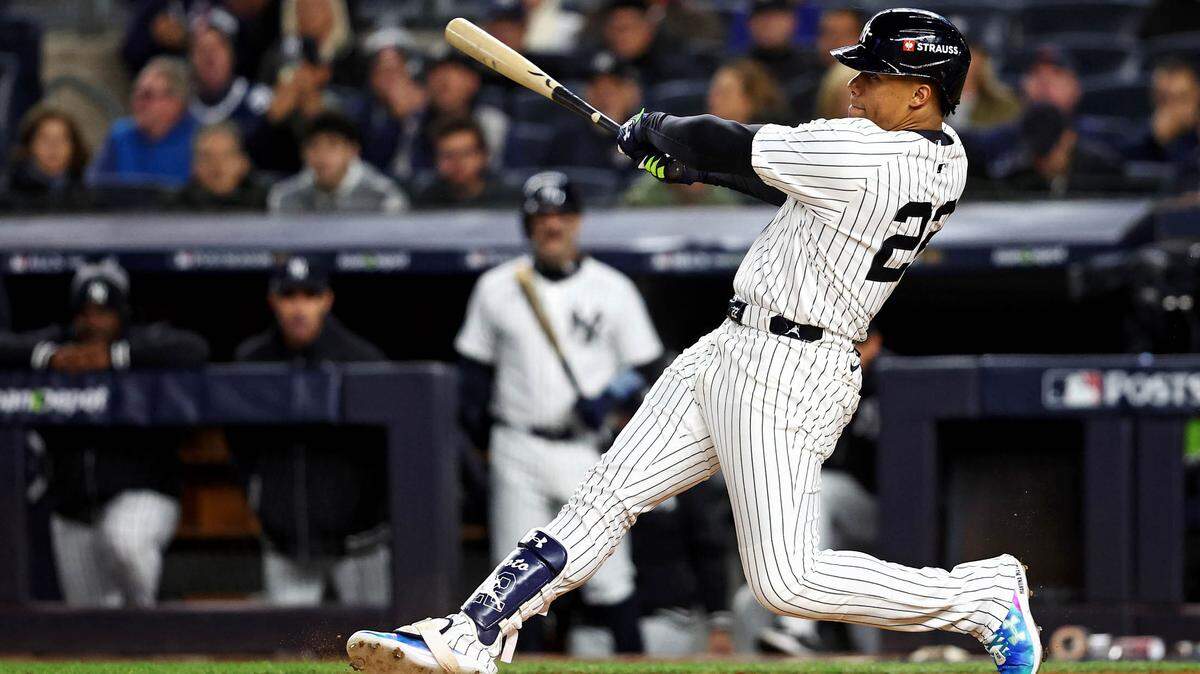 New York Yankees outfielder Juan Soto (22) hits a solo home run during the third inning against the Cleveland Guardians in Game 1 of the ALCS for the 2024 MLB Playoffs at Yankee Stadium.