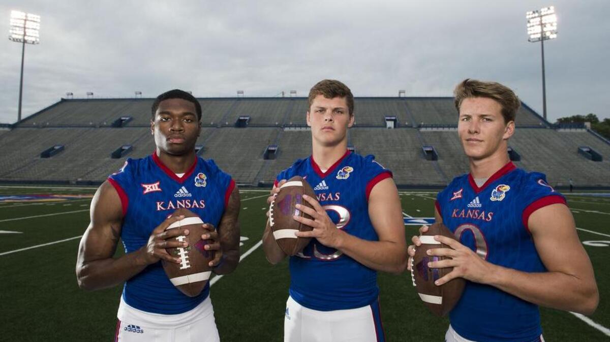 
University of Kansas quarterback Montell Cozart (left), University of Kansas quarterback Ryan Wills and University of Kansas quarterback Carter Stanley (right) during media day for the football team at Memorial Stadium at the Univeristy of Kansas on Saturday, August 8, 2015, in Lawrence, Kansas.
