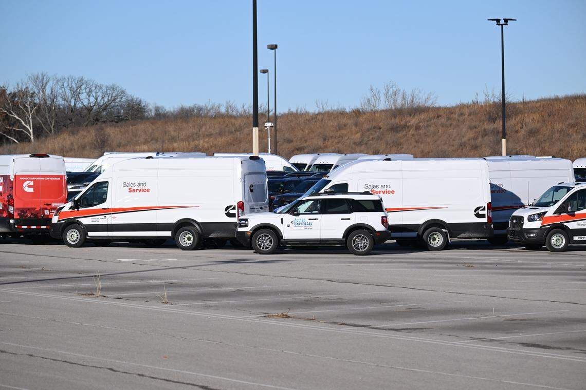ICE vehicles are blocked by vans and security vehicles in a lot near Worlds of Fun in Kansas City on Wednesday, January 14, 2026.