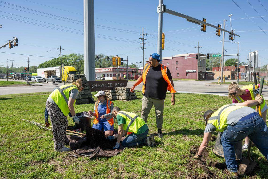 Heartland Tree Alliance Community Coordinator Jesus Valenzuela works with volunteers to plant trees at Shawnee Park in Kansas City, on Thursday, April 16, 2026. Armourdale Renewal Association and Bridging the Gap enlisted the volunteers to help plant trees in the park and nearby area.