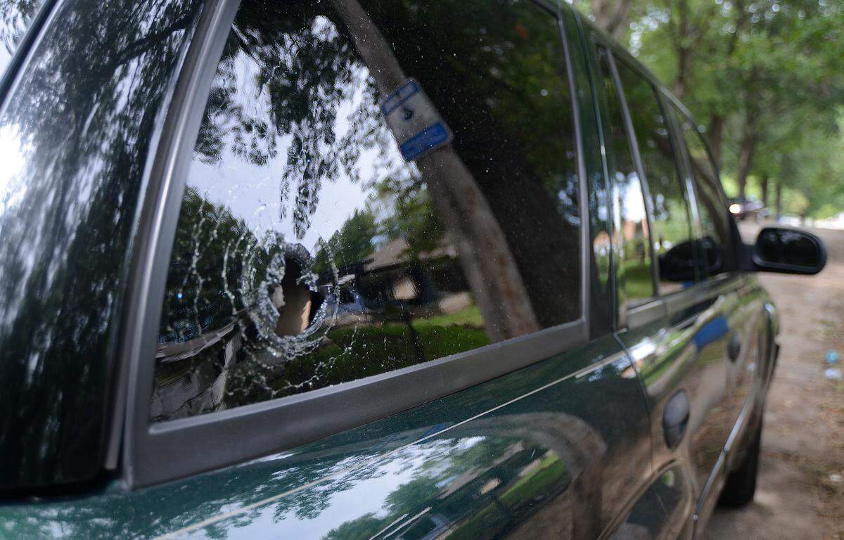 One of two bullet holes can be seen in Sasha Lowe’s truck outside her home Tuesday in Kansas City. 