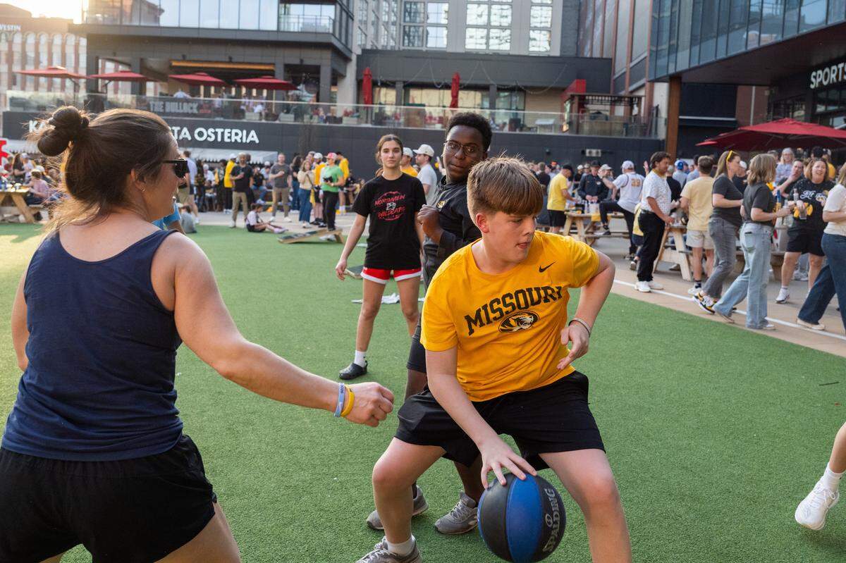 Missouri fans play a loose game of pickup basketball at the Mizzou Spirit Rally at Ballpark Village on Thursday, March 19, 2026, in St. Louis. The Missouri Tigers faced off against the Miami Hurricanes in the first round of the NCAA Men's Basketball Tournament in St. Louis.