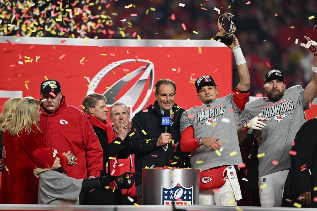 Kansas City Chiefs quarterback Patrick Mahomes hoists the Lamar Hunt Trophy on stage with tight end Travis Kelce after winning the AFC Championship Game on Sunday, Jan. 26, 2025, at GEHA Field at Arrowhead Stadium.