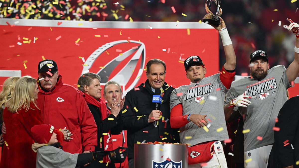 Kansas City Chiefs quarterback Patrick Mahomes hoists the Lamar Hunt Trophy on stage with tight end Travis Kelce after winning the AFC Championship Game on Sunday, Jan. 26, 2025, at GEHA Field at Arrowhead Stadium.