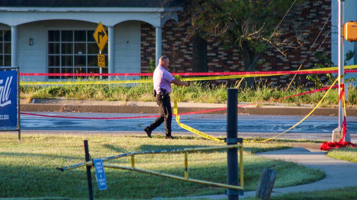 A driver fleeing police allegedly swerved intentionally toward a Kansas City, Kansas, police officer who was deploying tire-deflating devices early Tuesday, striking and critically injuring the officer. The crash occurred around midnight near West 75th Street and State Avenue. A law enforcement officer rolls up crime scene tape as the investigation concludes at the scene.