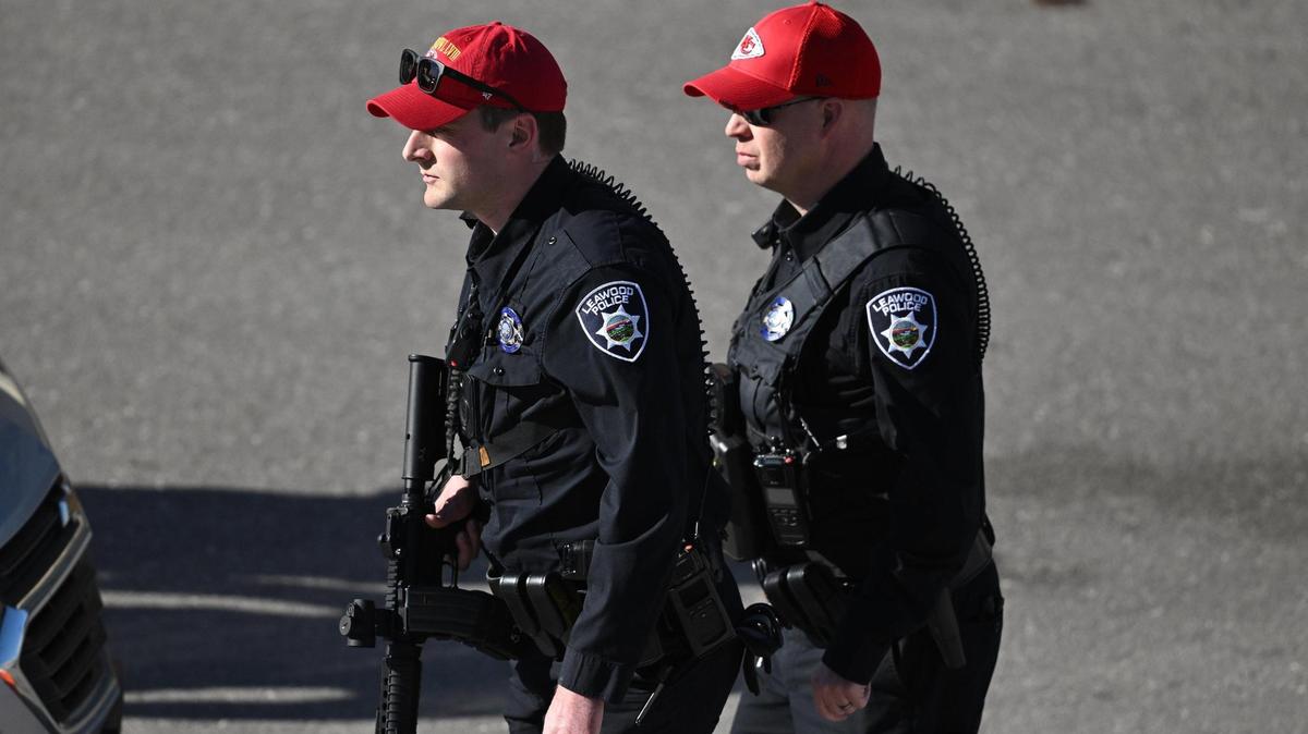 Two Leawood police officers walk near the scene of a shooting at Union Station after the Kansas City Chiefs Super Bowl LVIII victory parade on Wednesday, Feb. 14, 2024, in Kansas City.