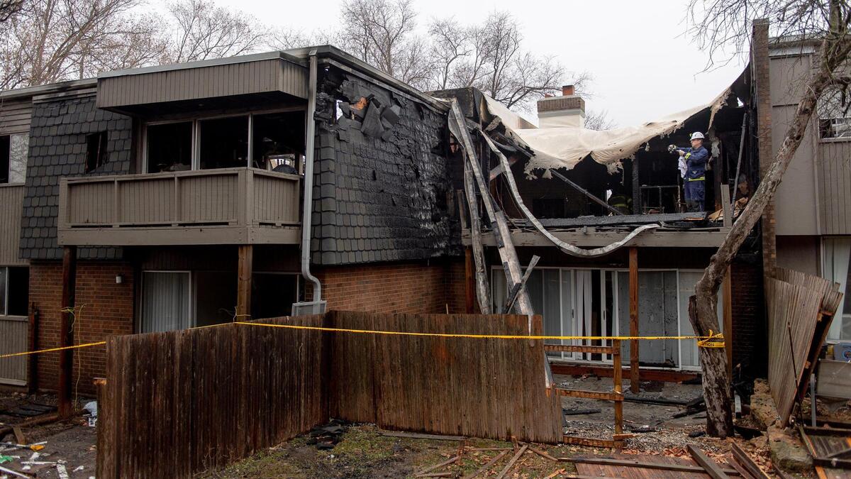 An Overland Park fire investigator documents an apartment that was destroyed in a fire at the Meadowlark Hill Apartments on Thursday, Dec. 8, 2022, in Overland Park, Kan.