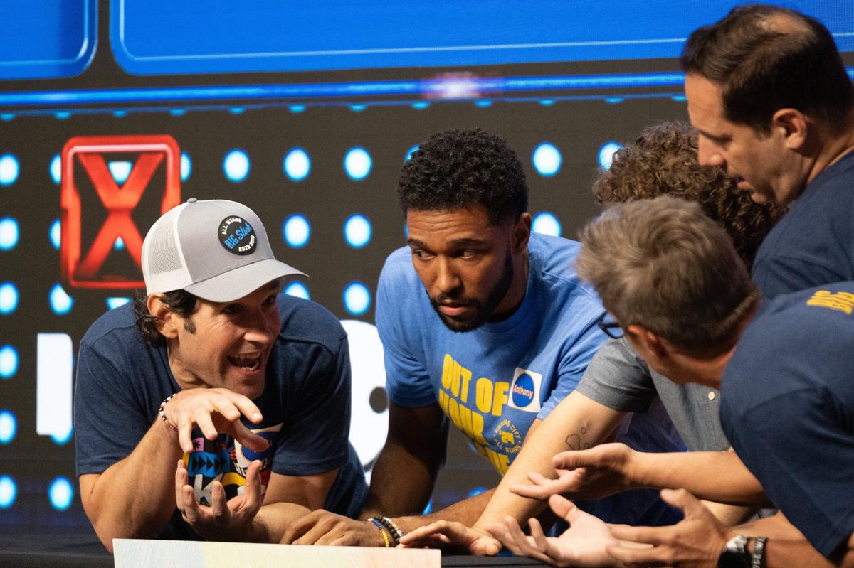 Paul Rudd’s team huddles to discuss answers during a round of Friendly Feud at the Big Slick Press Conference on Friday, May 31, 2024, at Children’s Mercy Research Institute.