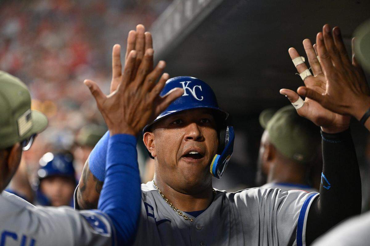 Kansas City Royals catcher Salvador Perez high-fives teammates after scoring against the Cardinals during a series-opening game at Busch Stadium in St. Louis on Friday, May 15, 2026.