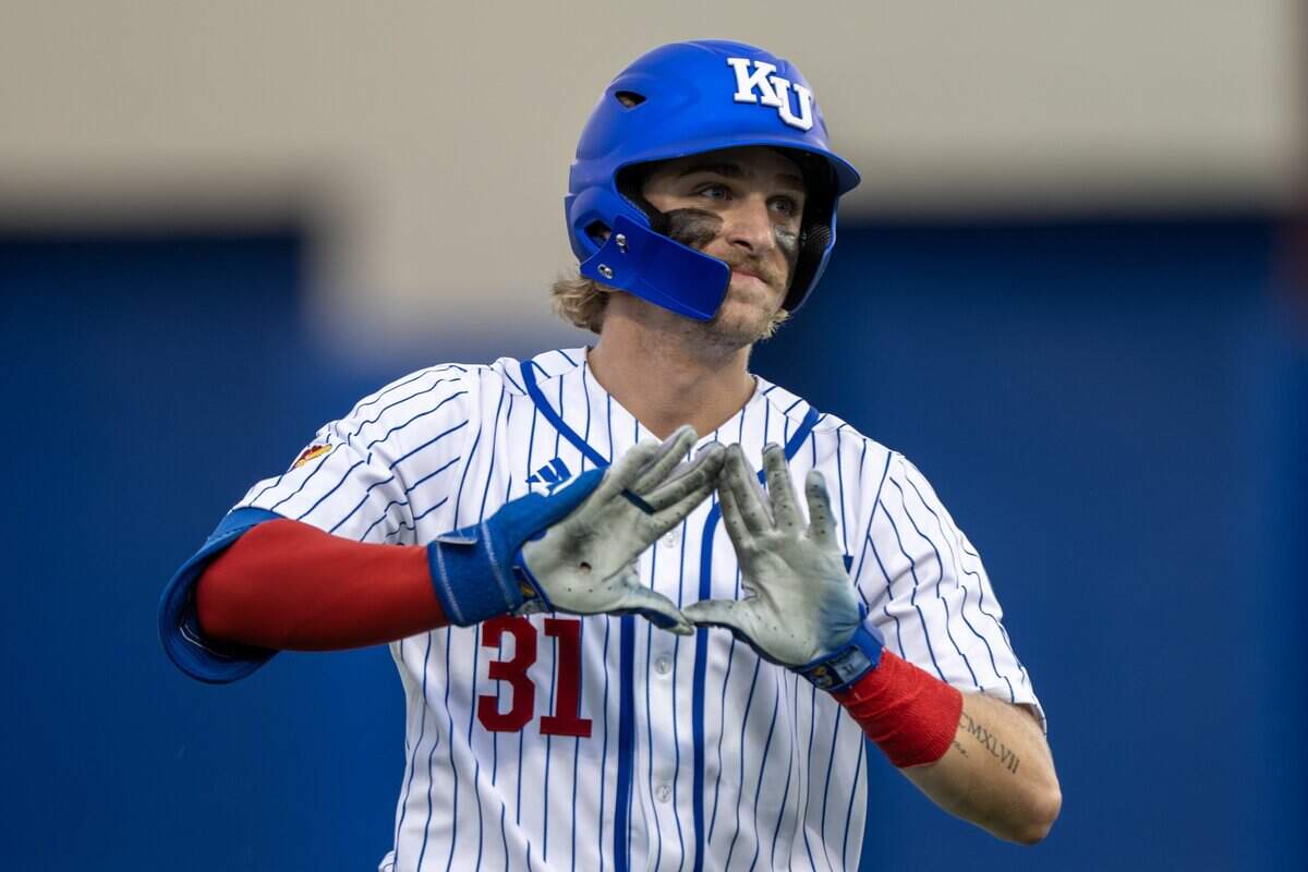 Kansas utility player Jordan Bach (31) celebrates after hitting a solo home run in the eighth inning of an NCAA Tournament baseball game against Oklahoma at Hoglund Ballpark on Saturday, June 6, 2026, in Lawrence.