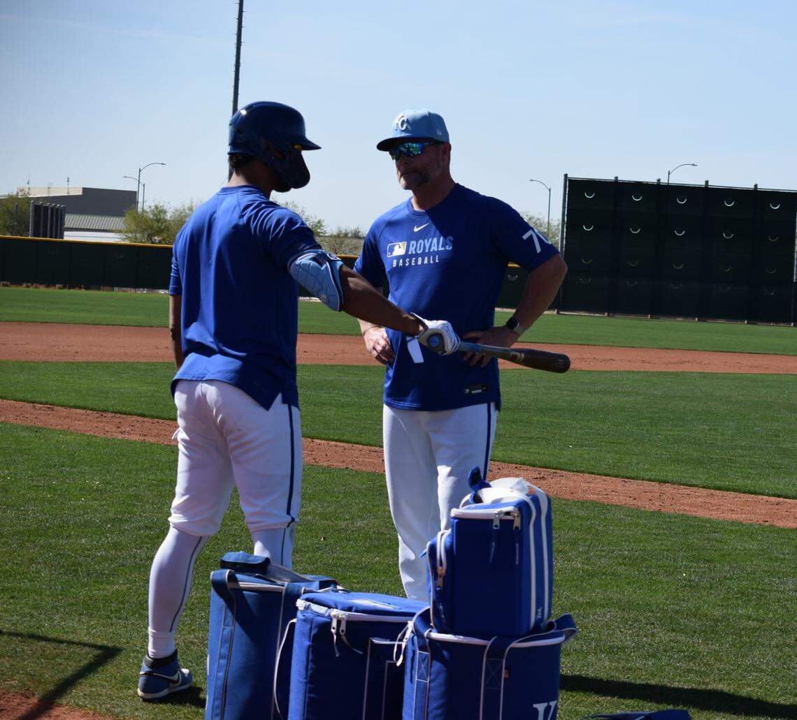 Kansas City Royals outfielder MJ Melendez talks with Royals assistant hitting coach Joe Dillon about his swing during the club’s spring training workout in Surprise, Arizona.