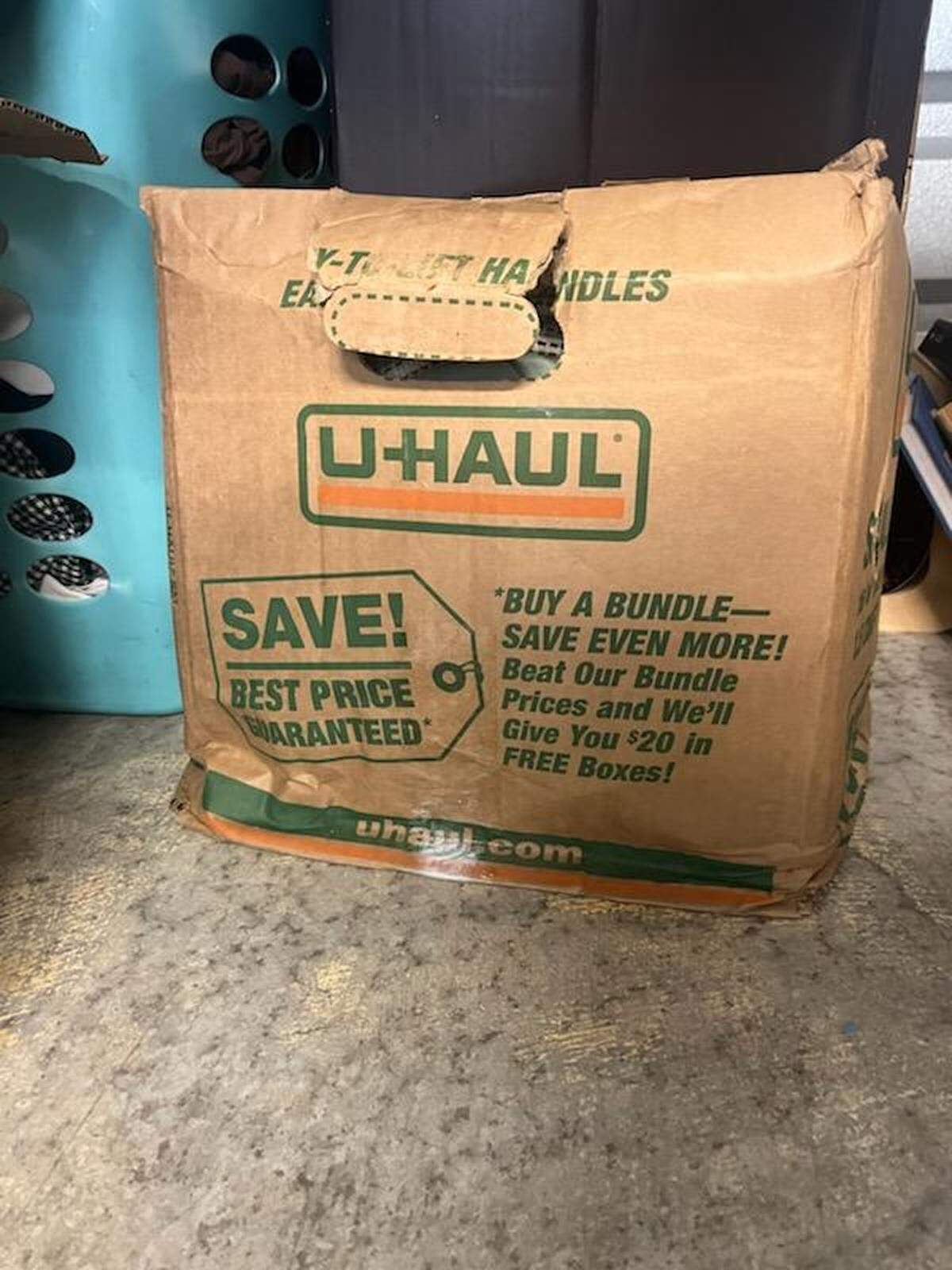 One of Shelbi Hussong’s damaged boxes, which was held in a Kansas City Public Storage facility, is seen in a provided photo. The company told tenants a July 4 rain storm flooded the unit.