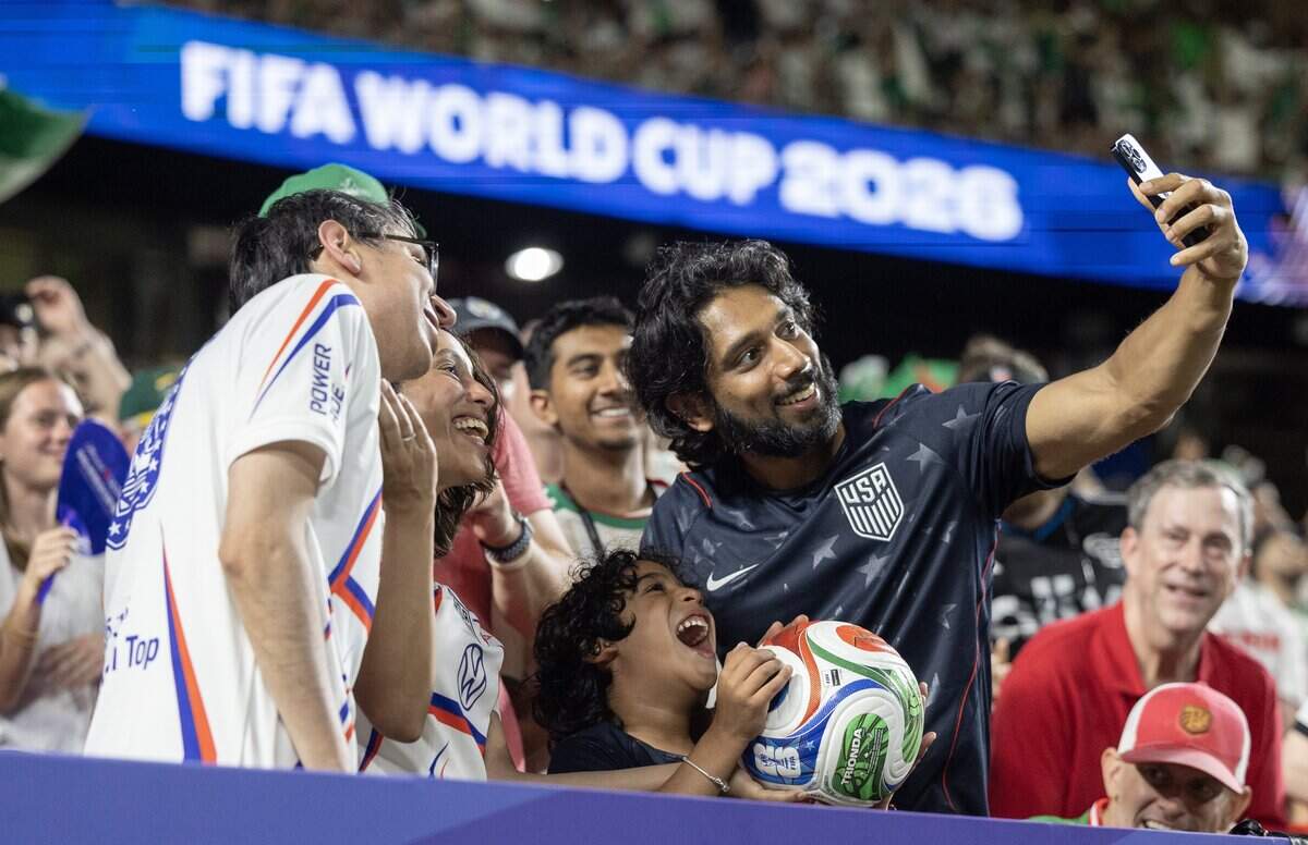 Fans who caught a ball that was kicked into the stands take a selfie during a FIFA World Cup group-stage soccer match between Austria and Algeria at Kansas City (Arrowhead) Stadium in Kansas City on Saturday, June 27, 2026.