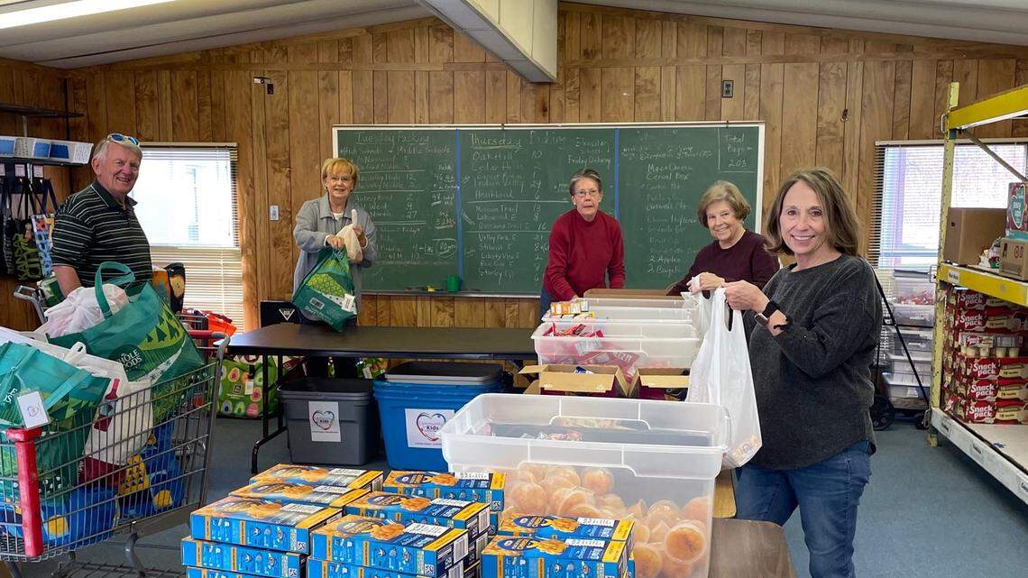 This group has been helping Community for Kids since the beginning. From left to right is Bob Wolf, Claudia Wolf, Terry Sinclair, Lonna White and Gloria Garrett. On this particular day in December, the group assembled 122 food packs for delivery the next day..