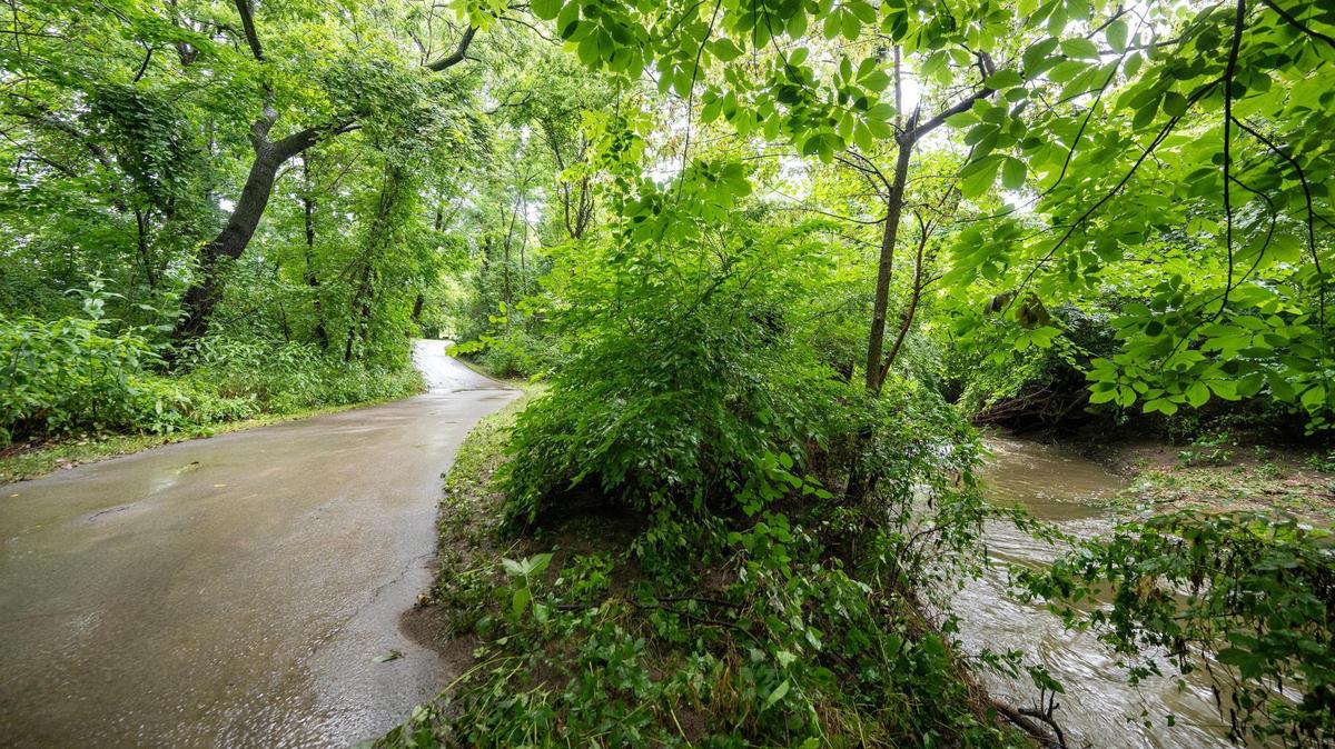 A woman died in flash flooding as she was walking along a trail near West 155th and Nall Ave., in Overland Park on Monday torrential rains drenched the southern part of the metro. The heat and humidity could fuel additional storms and downpours on Tuesday.