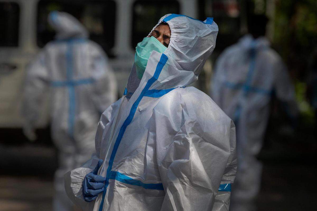The fiancee of a person who died of COVID-19 breaks down during cremation in Gauhati, India, Tuesday, April 27, 2021. Coronavirus cases in India are surging faster than anywhere else in the world and the country is reporting 350,000 new cases a day, more than anywhere else in the world.