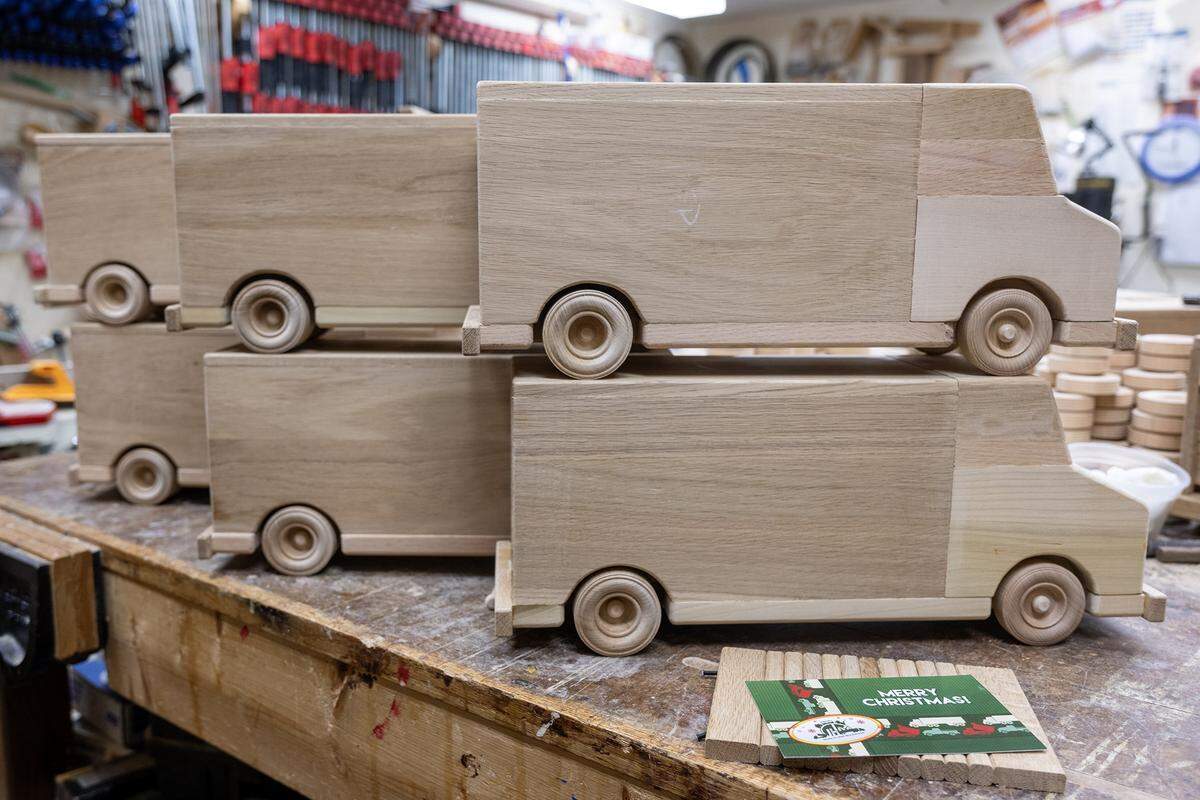 Since August, Jay Morris of JHM Woodworks and his volunteers have been transforming donated wood scraps into toy trucks, as seen on Tuesday, Dec. 2, 2025, in Lawrence, Kansas. Morris plans to donate all 115 handcrafted trucks to children in need through the Toys for Tots program.