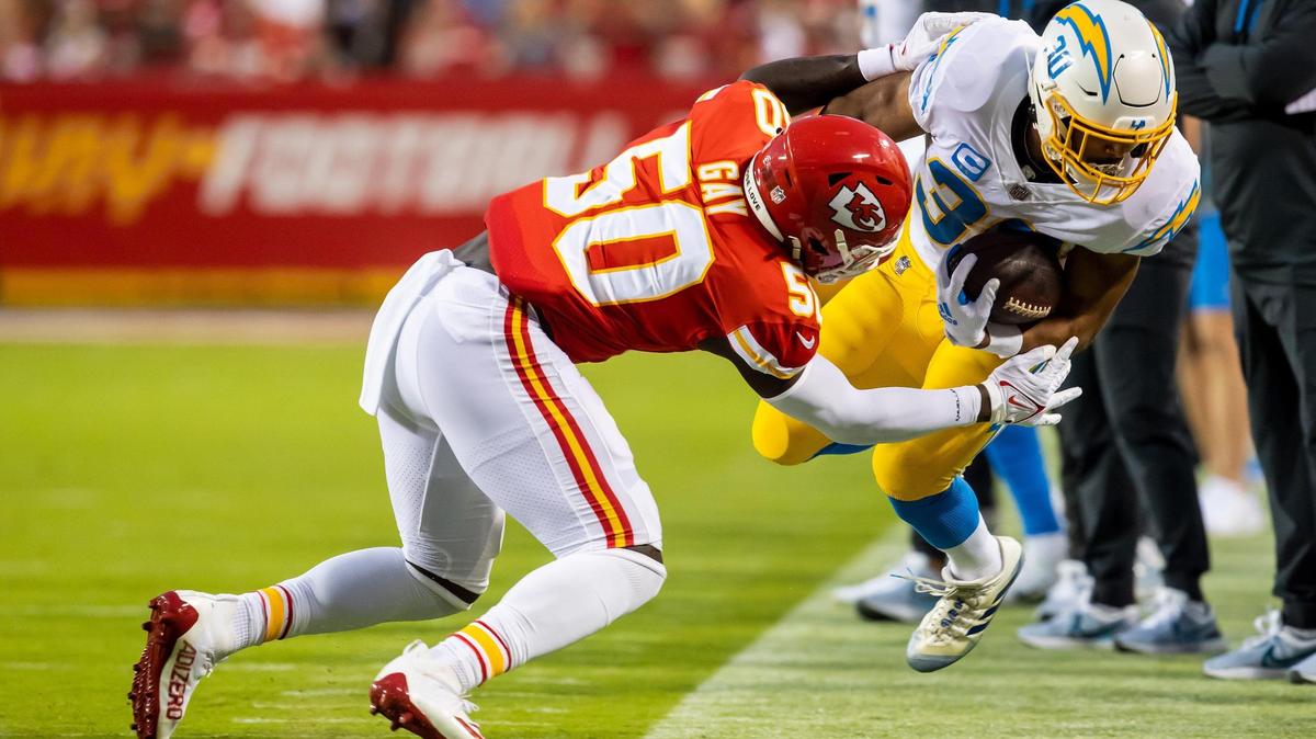 Kansas City Chiefs linebacker Willie Gay (50) knocks Los Angeles Chargers running back Austin Ekeler (30) during the home opener game between the Kansas City Chiefs and the LA Chargers on Thursday September 15, 2022 at Arrowhead Stadium in Kansas City, Missouri
