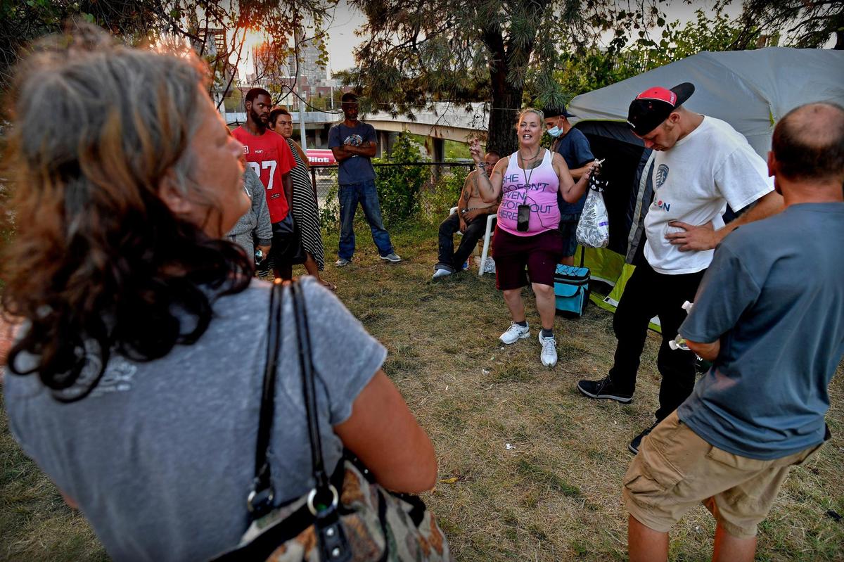 During a meeting of those living at the encampment, Livingston, middle, lays down the law about camp rules and doles out helpful advice about keeping their encampment safe from thieves. In recent days, groups from other camps came by and nabbed food and water. There’s room for generosity, she told them, but if they take everything, there’s nothing left for her camp. “We are a union,” she reminded them. “We work together.”