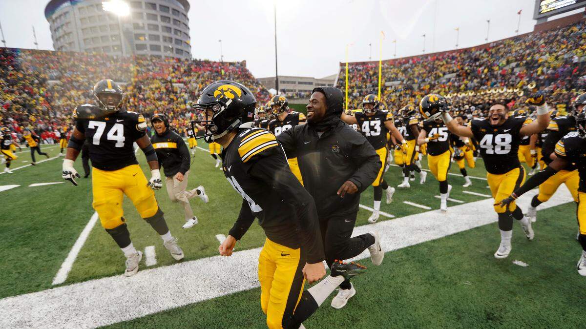Iowa placekicker Miguel Recinos (center) celebrated with teammates after making a 41-yard field goal on the final play of an NCAA college football game against Nebraska, Friday, Nov. 23, 2018, in Iowa City, Iowa.