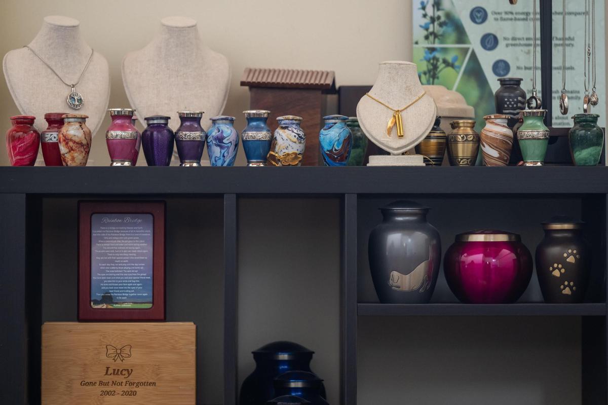 Urns and necklaces that can hold the cremated remains on pets on display at Heartland Pet Aquamation in the West Bottoms. The urns for a pigeon or gerbil can be smaller than a shot glass.