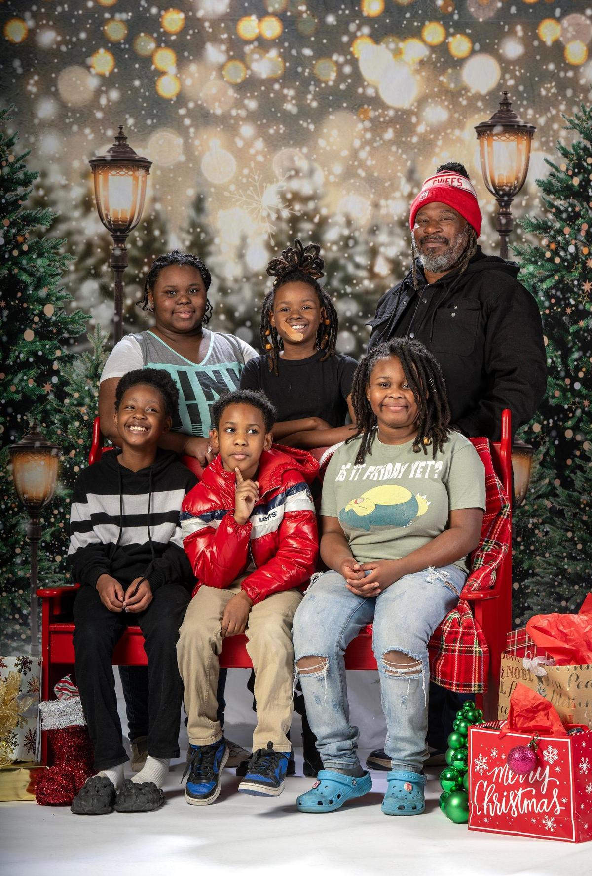Ileeyah Jeffery, back row from left, Laycie Henderson, Derrick Benson and Lauren Henderson, front row, Zayshad Jeffery, Shai Jeffery have their photo taken on Thursday, Dec. 12, 2024, at the Plaza Branch Library in Kansas City.