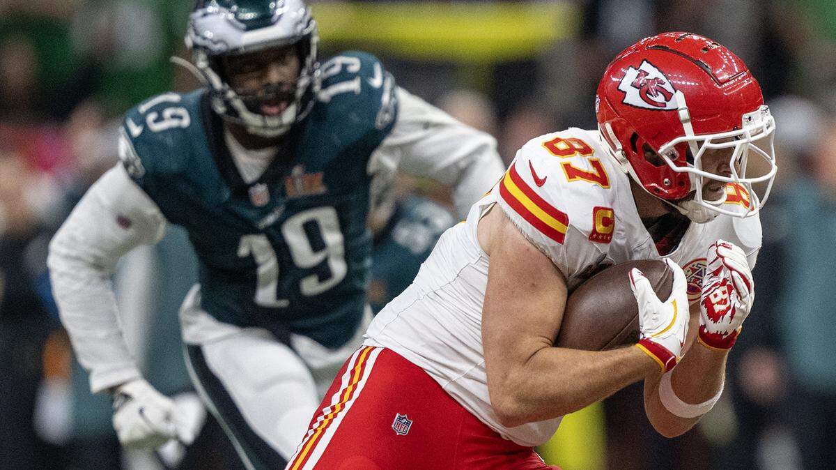 Kansas City Chiefs tight end Travis Kelce (87) runs with a pass as Philadelphia Eagles linebacker Josh Sweat (19) goes after him in the second half of Super Bowl LIX on Sunday, Feb. 9, 2025, in New Orleans.