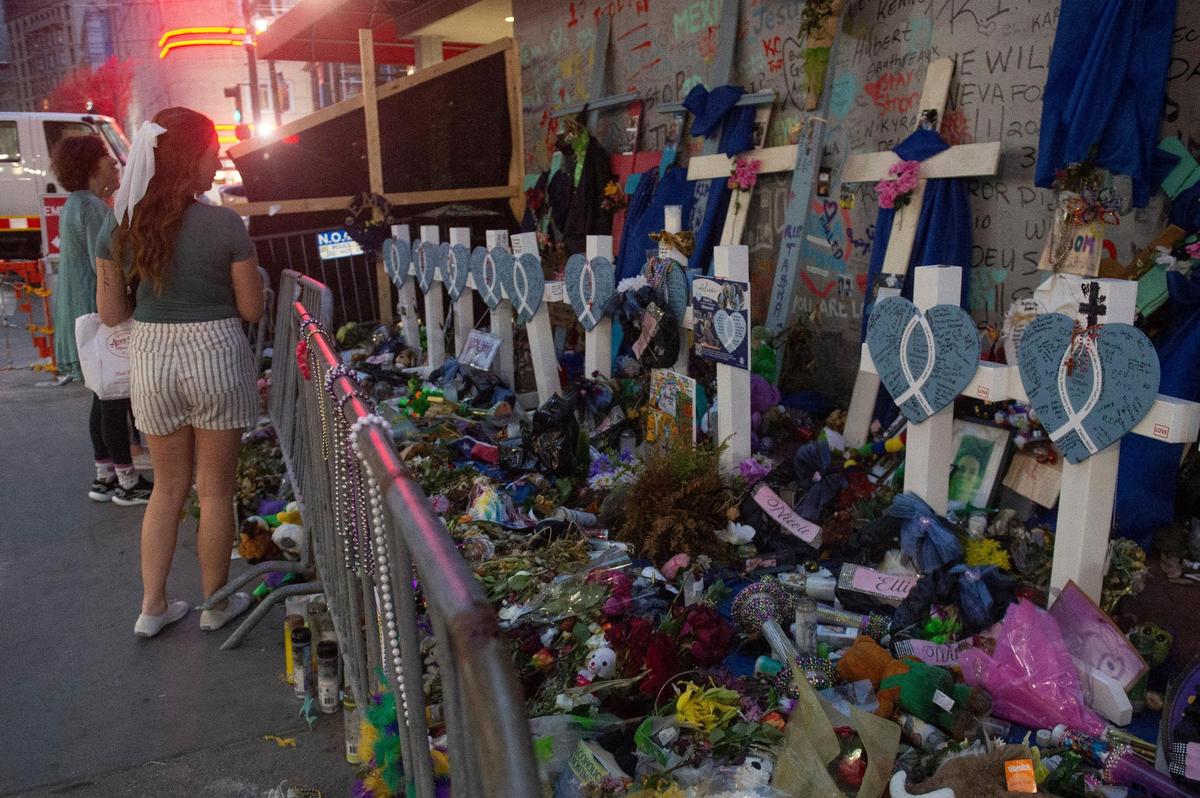 Tourists visit a makeshift memorial for the Jan. 1 terrorist attack along Bourbon Street in New Orleans on Thursday, Jan. 30. Fourteen people were killed when a man, inspired by the Islamic State, drove a pickup truck through a late-night crowd on Bourbon Street before firing shots.