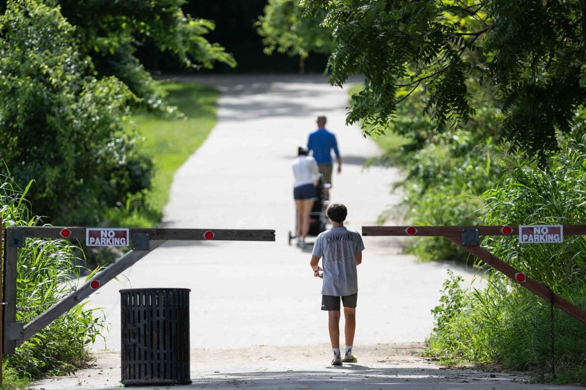People walk along Line Creek Trail in Kansas City. You’ll encounter waterfalls along the 8-mile path.