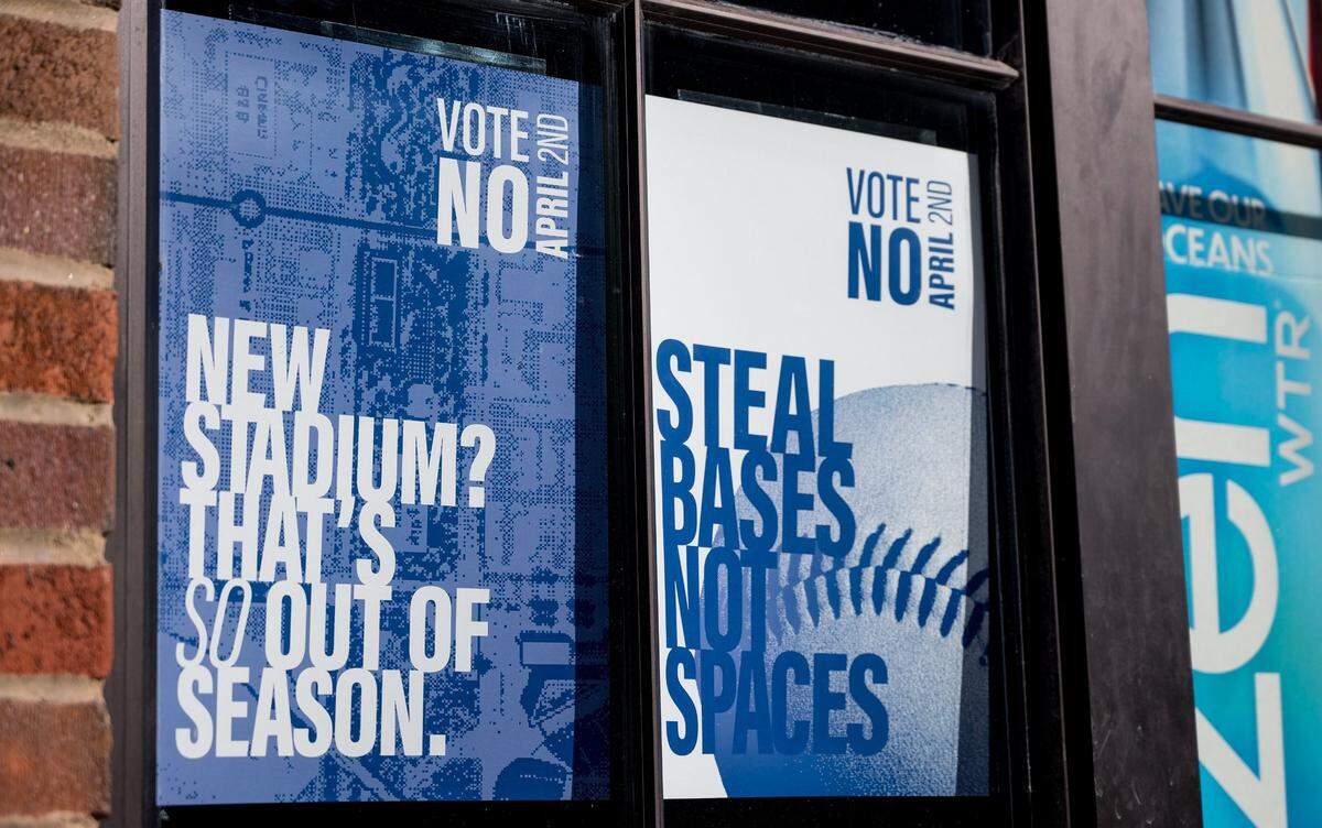 Signs in a Kansas City window urge voters to vote against a 40-year, 3/8th-cent sales tax to pay for a new Royals stadium and improvements to Arrowhead Stadium.