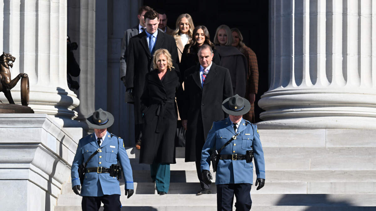 Missouri Governor-elect Mike Kehoe, with his wife Claudia, are escorted by state troopers to his inauguration ceremony Monday on the steps of the Missouri State Capitol in Jefferson City.