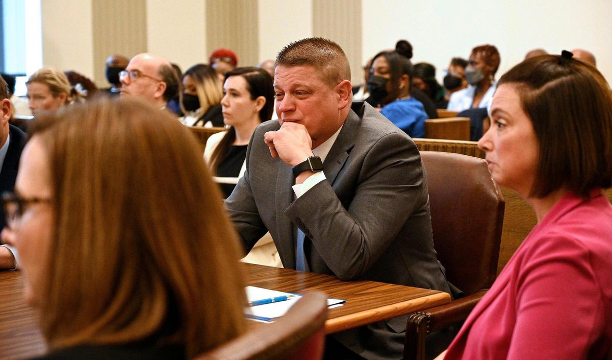 Former Kansas City police detective Eric DeValkenaere, center, became emotional as he listened to his father, Albert DeValkenaere, give a statement during his sentencing hearing Friday, May 4, 2022. Seated near DeValkenaere were attorneys Dawn Parsons, left, and Molly Hastings. DeValkenaere was sentenced to six years in the Dec. 3, 2019, killing of Cameon Lamb.