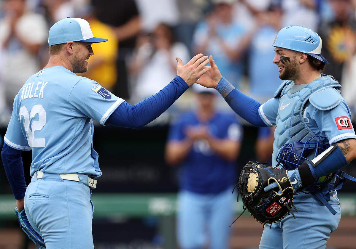 Royals pitcher Stephen Kolek, left, shakes hands with catcher Carter Jensen after pitching a complete game in shutting out the Seattle Mariners 5-0 at Kauffman Stadium in Kansas City on Saturday, May 23, 2026.