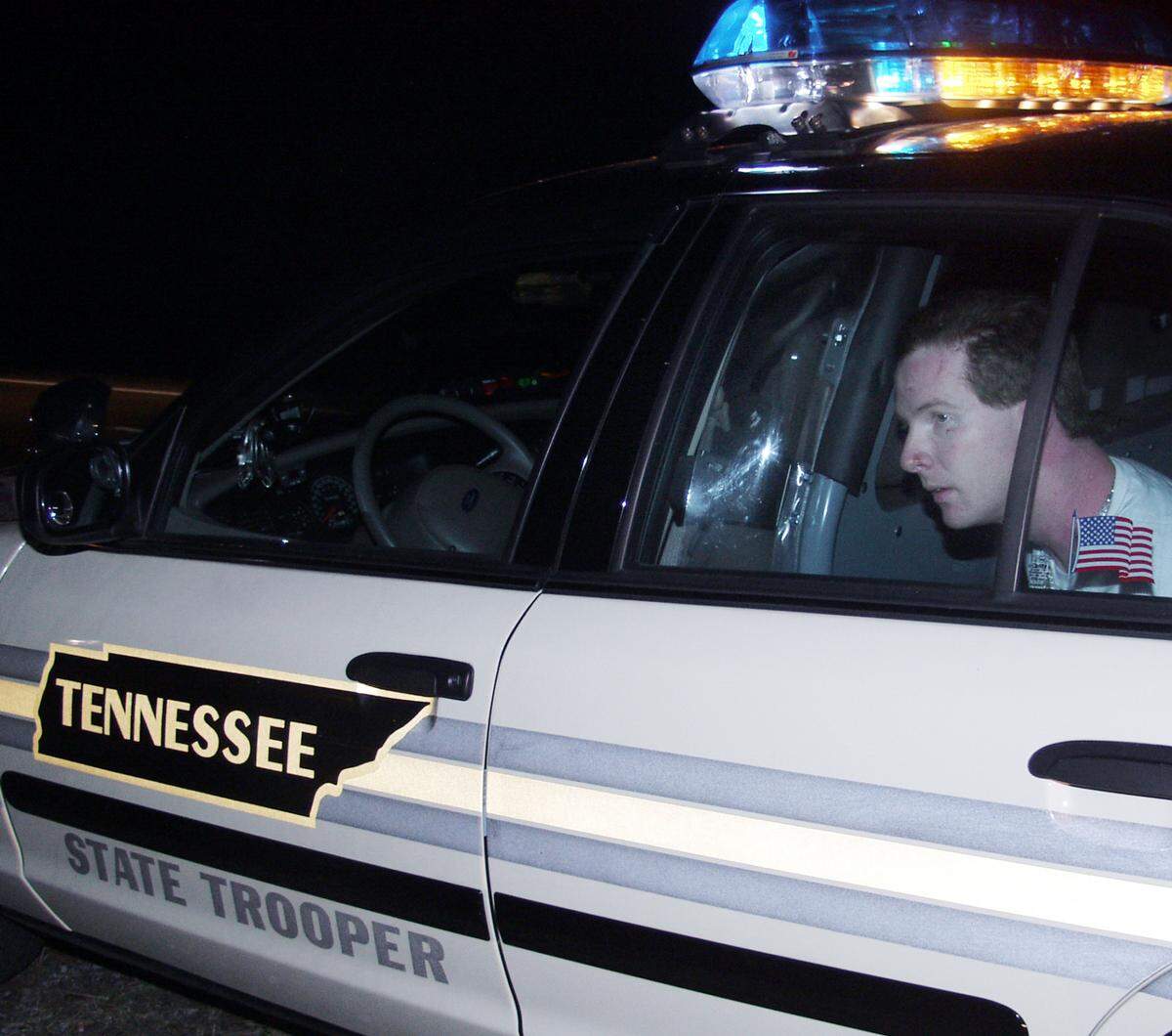John Manard a convicted murderer is seen after his capture, Friday, Feb. 24, 2006, near Sweetwater, Tenn. A prison volunteer Toby Young and Manard were caught Friday night in Tennessee, Kansas prison officials said. Minor injuries were reported during the capture. Toby Young was taken to a local hospital as a precautionary measure. Authorities have said the daring escape was carefully planned, that the two had more than $10,000 in cash and two semiautomatic weapons, and that they bought hair coloring and an electric razor that may have been used to alter appearances. (AP Photo/Daily Post-Athenian, Doug Headrick)