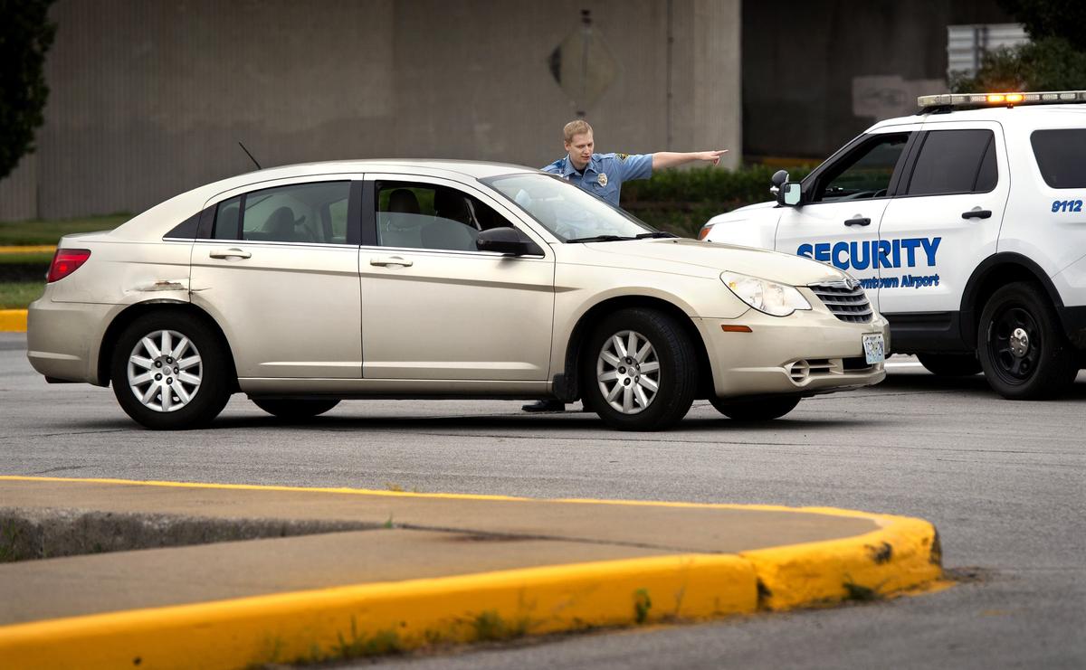 Wheeler Downtown Airport security officer Roger Skorepa gave directions to a motorist while patrolling the airport’s perimeter. Skorepa has been interested in aviation since childhood.
