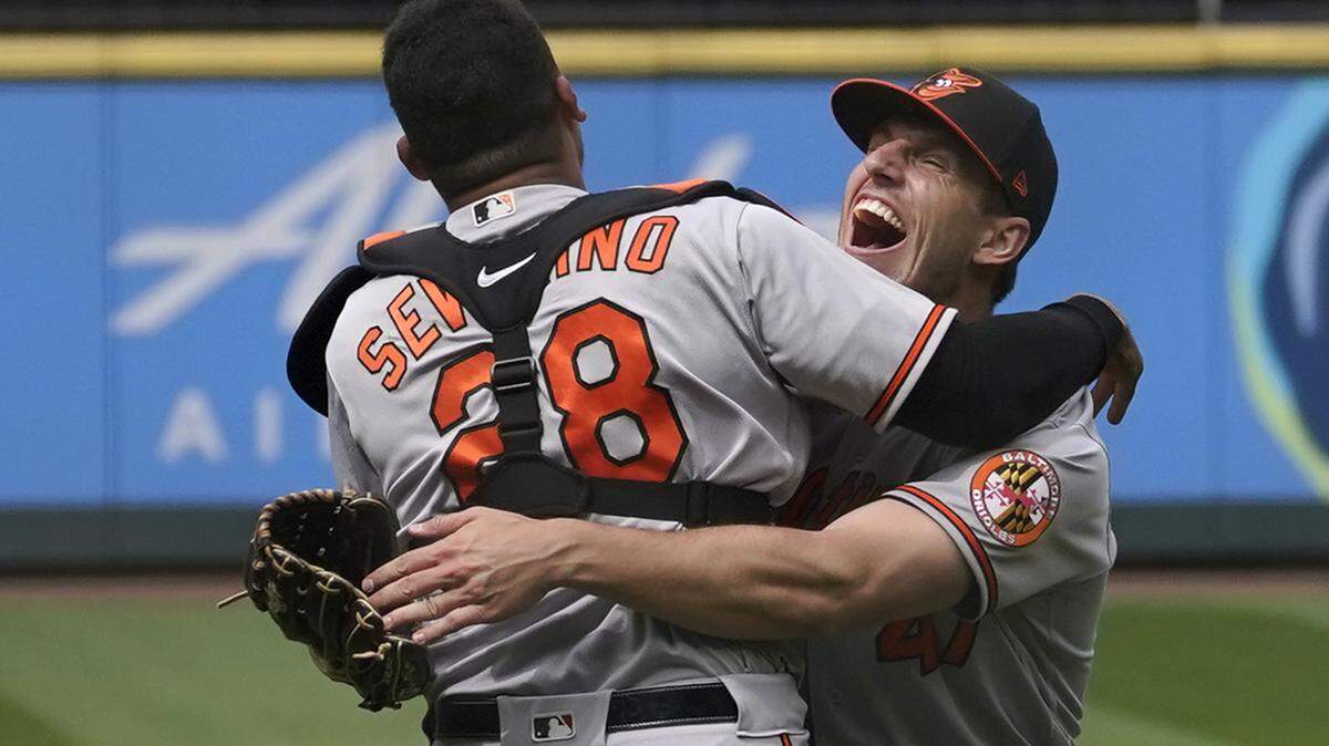 Baltimore Orioles starting pitcher John Means, right, hugs catcher Pedro Severino after Means threw a no-hitter in the team’s baseball game against the Seattle Mariners, Wednesday, May 5, 2021, in Seattle. The Orioles won 6-0. (AP Photo/Ted S. Warren)