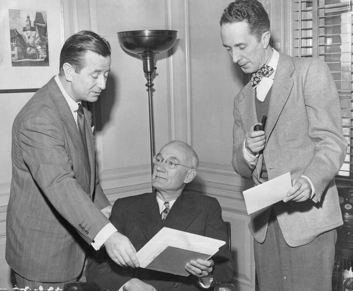 In this 1948 photo, Hallmark president Joyce C. Hall joins Harry Abrams and renowned illustrator Norman Rockwell to announce a partnership with Gallery Artists of New York. The agreement brings fine art to greeting cards, with Rockwell among the 50 artists creating exclusive designs for Hallmark.