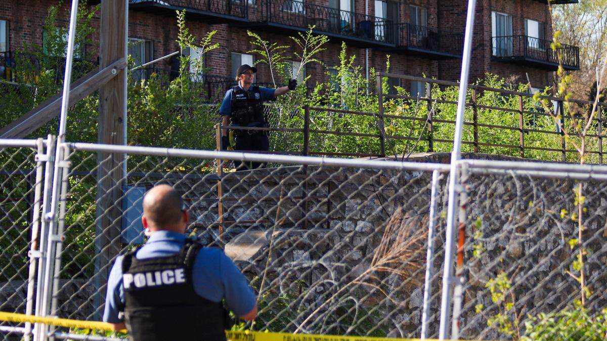 Police process a crime scene where a decomposing body was found near Troost and 81st Street on April 13, 2024.