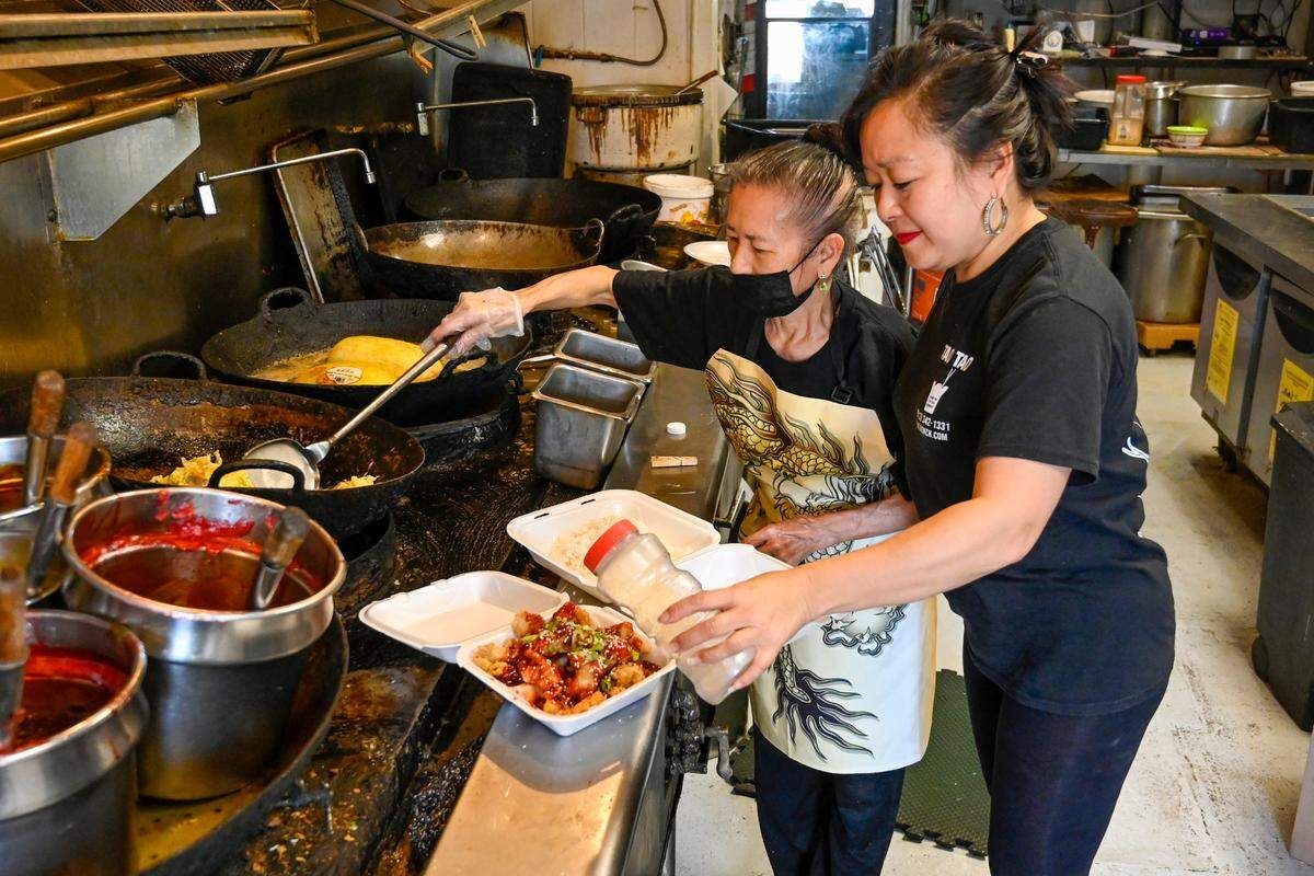 Chef Annie Der, left, 75, and her daughter, Tina Der, prepare meals in the kitchen at Tao Tao Chinese Restaurant in Kansas City, Kansas. The restaurant celebrated its 50th anniversary earlier this year.