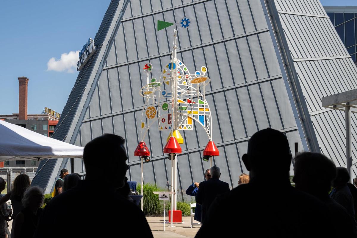 Onlookers take in Union Station’s newest sculpture titled ‘Journey to Wonder,’ on Thursday, June 26, 2025. The sculpture is 28-feet tall and features kinetic elements and light and sound effects.