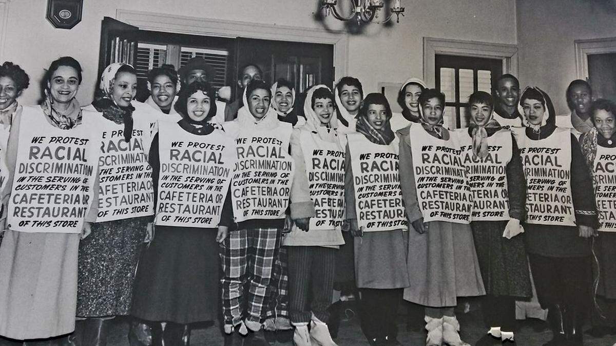 Bettylu Donaldson (fourth from left, wearing plaid pants) poses with other Black Kansas City activists during the winter of 1958, when there were many protests over segregated dining at department stores. She brought her children with her to one of the protests to show them how important it was to speak up.