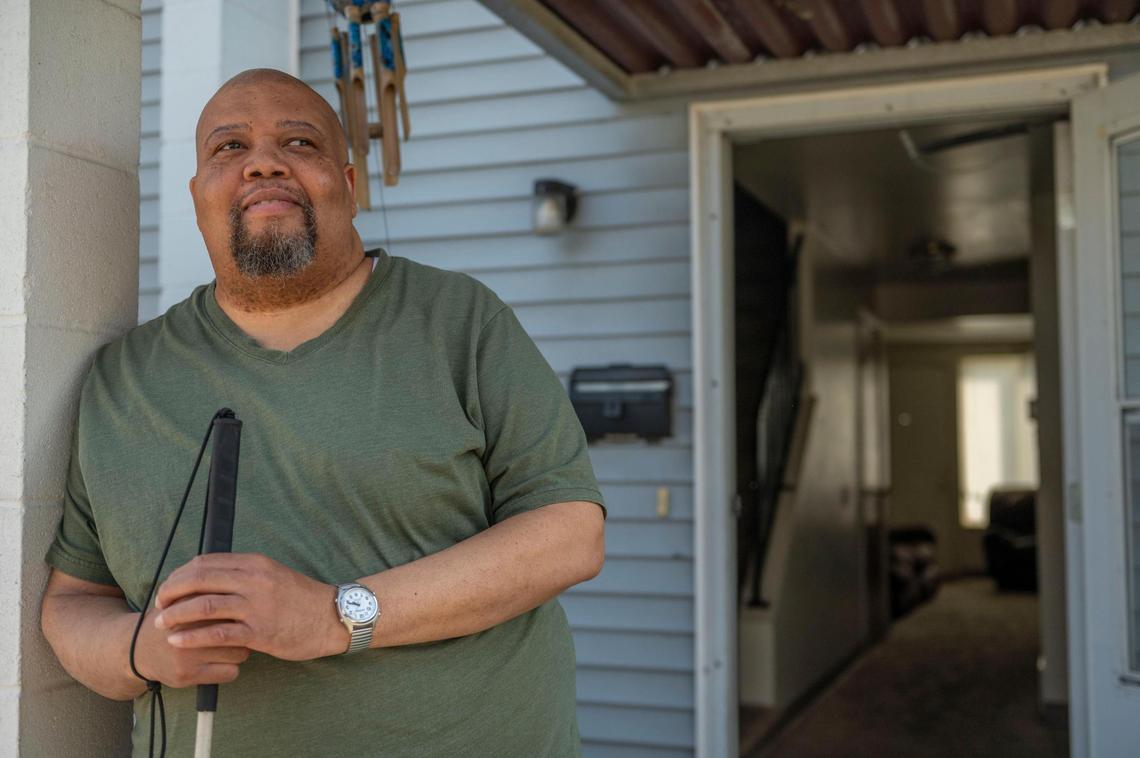 Darrin Sherman stands outside his front door at his townhome in Kansas City on Tuesday, April 12, 2022. Sherman, a resident of Parade Park Homes since April 2013, recently moved to south Kansas City after a water leak in his home led to severe damage. He repeatedly called for management to help him but the problem was never fixed, he said.