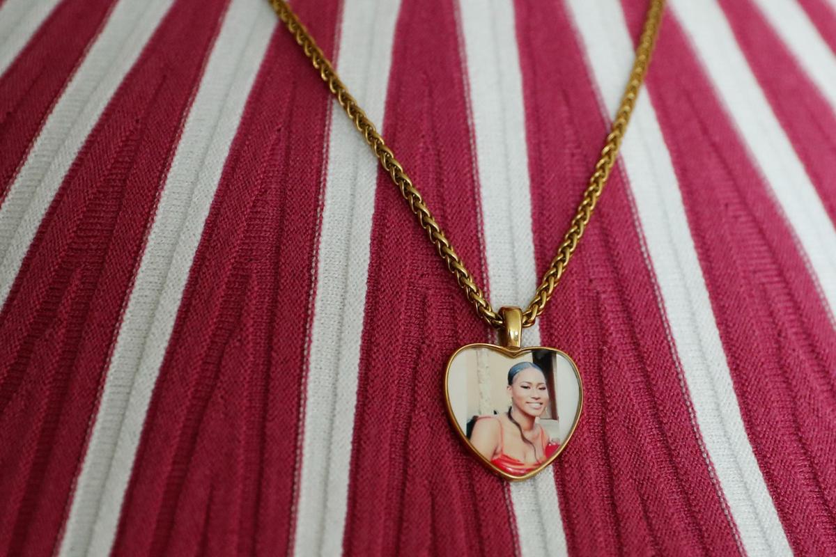 Jenele Hughes wears a heart-shaped necklace containing a photograph of her daughter, Amauri Hughes.