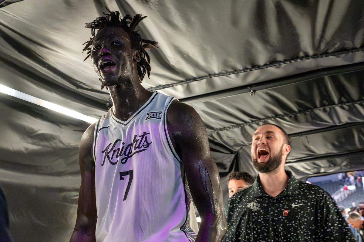 UCF center John Bol (7) yells as he walks through a lit tunnel after defeating Cincinnati 66-65 in overtime in a Big 12 Men's Basketball Tournament game at T-Mobile Center on Wednesday, March 11, 2026, in Kansas City