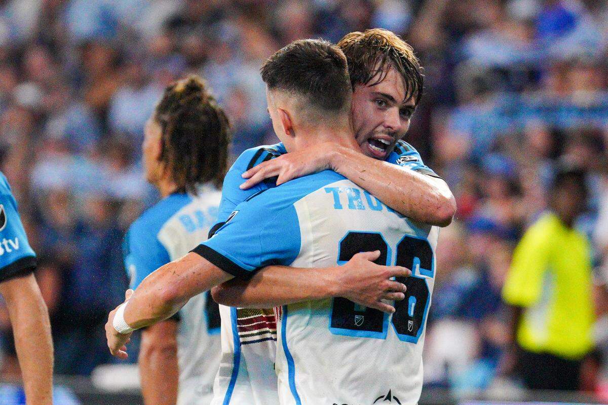 Sporting Kansas City midfielder Jake Davis (17) celebrates with midfielder Erik Thommy (26) after scoring against Orlando City during the first half at Children’s Mercy Park on Aug. 24, 2024.